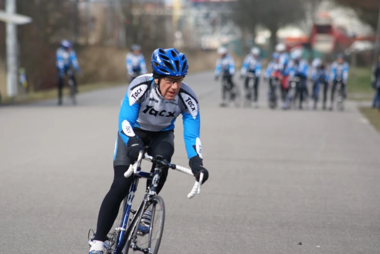 a man riding a bike down the middle of a street