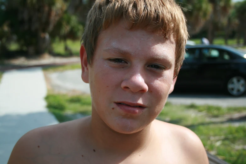 a close - up s of a boy's face, which is partially obscured by the camera lens