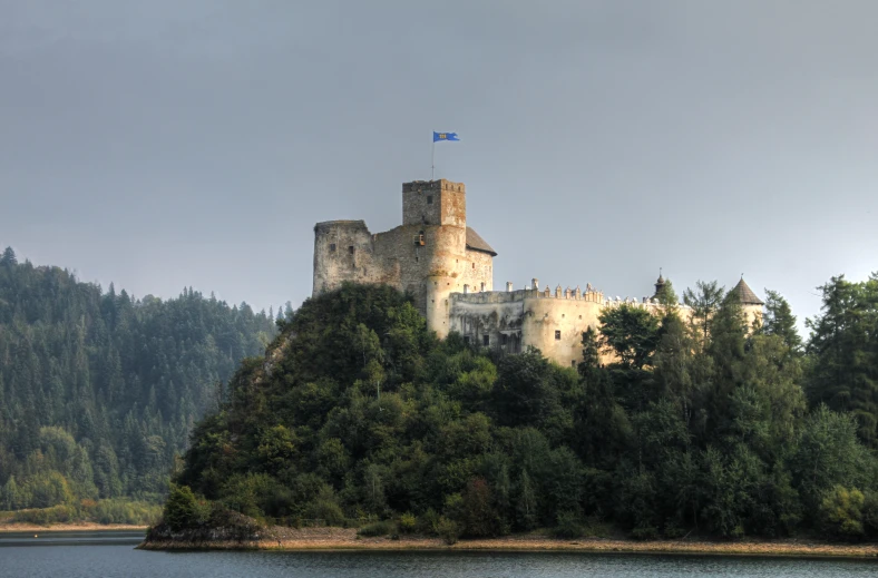 a castle on a cliff overlooking a lake