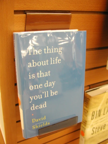 a book on display next to a book shelf