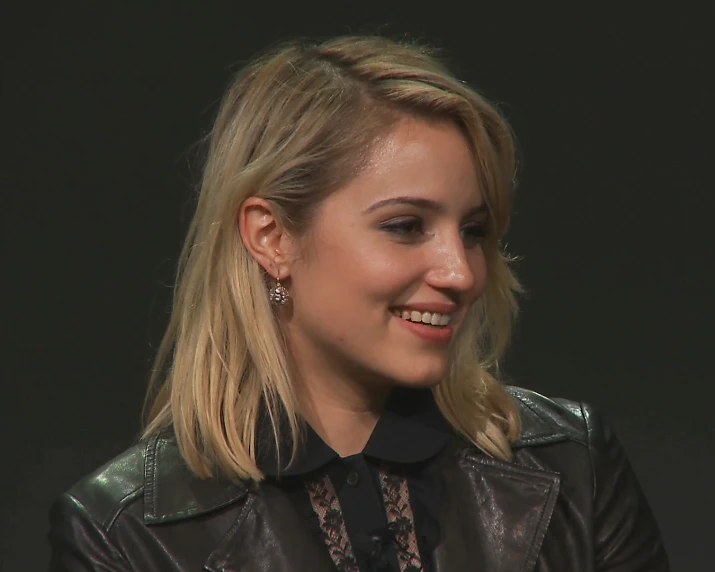 a girl smiles while she talks at an event