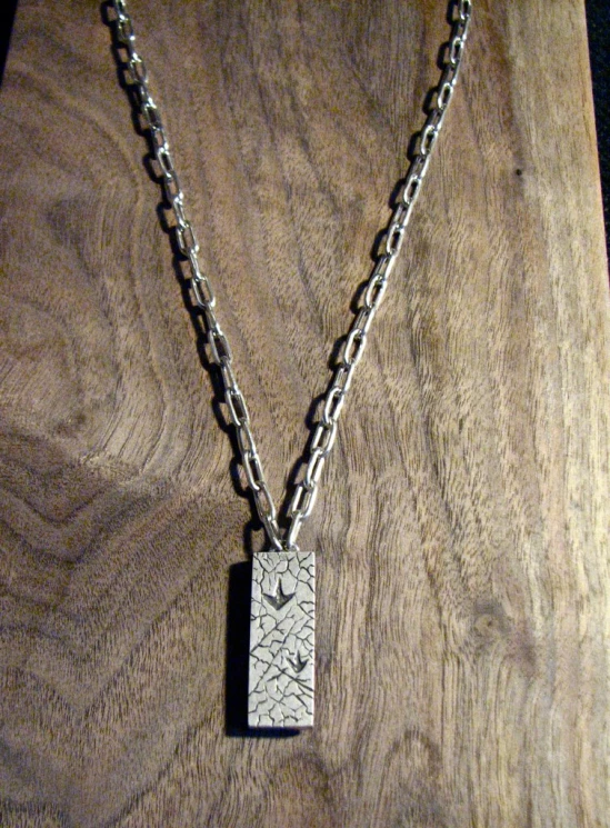 this is an image of a necklace with a square piece