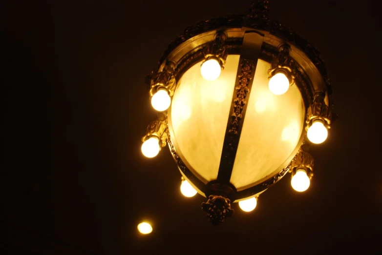 an ornate light fixture lit up at night with lots of light