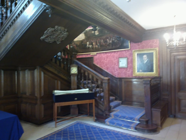 a living room with a blue carpet and two stairs