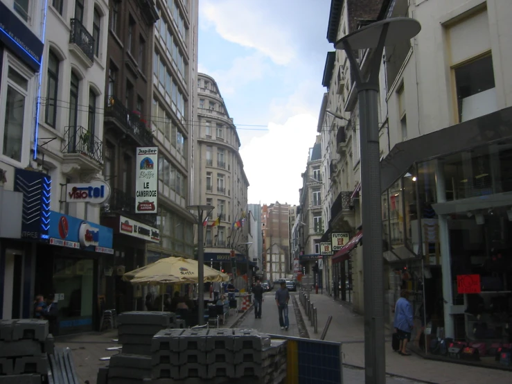 people walking through the middle of a city street