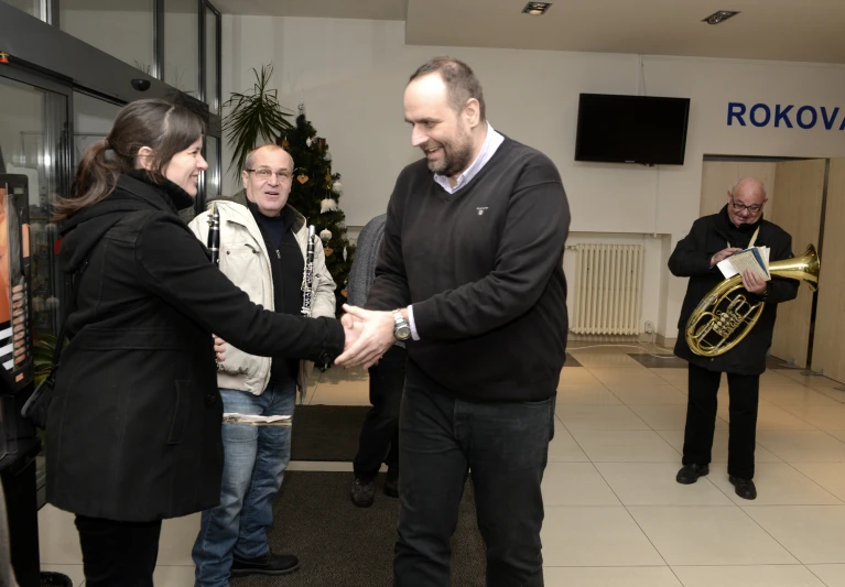 a man and a woman shaking hands in a room