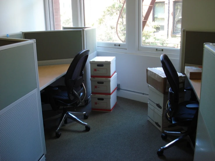 an office room with boxes and a computer