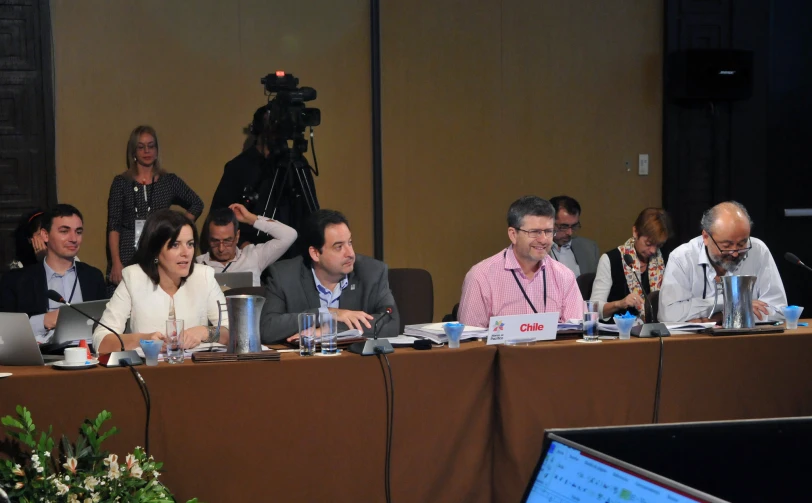 people sitting in a conference room during a presentation