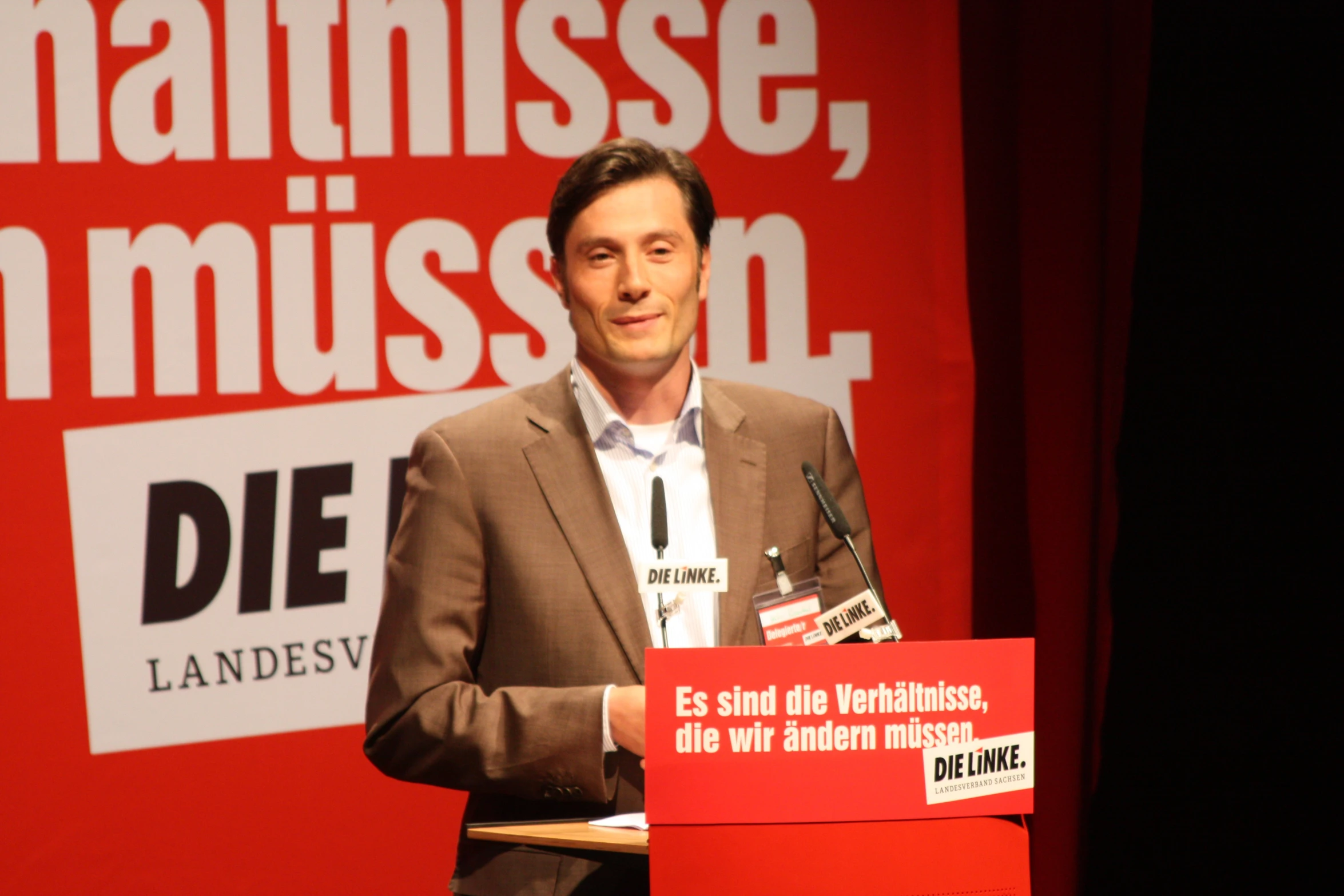 a man giving a speech on stage at an event