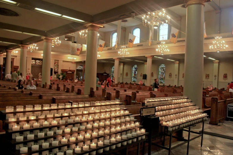 a church filled with lots of candles inside of it