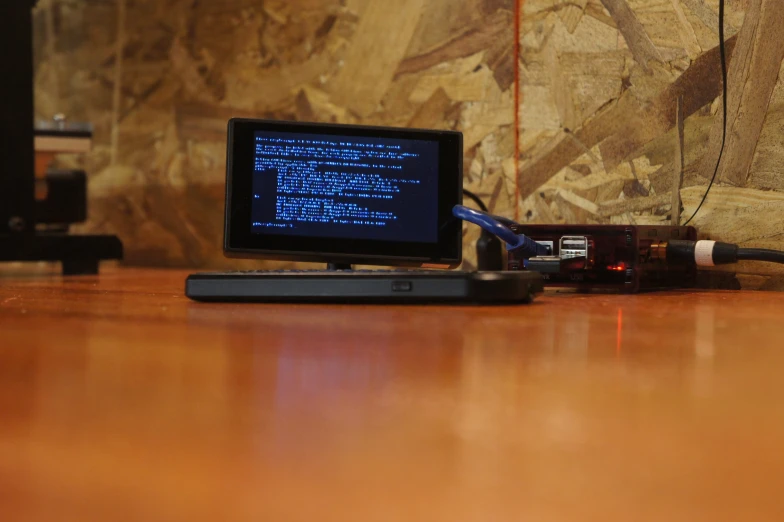 a computer sitting on a table with a laptop