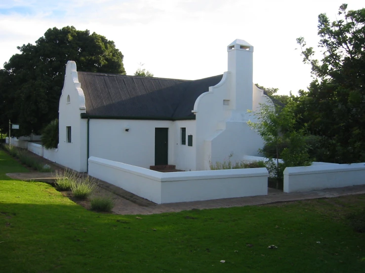 a white house on the side of a street