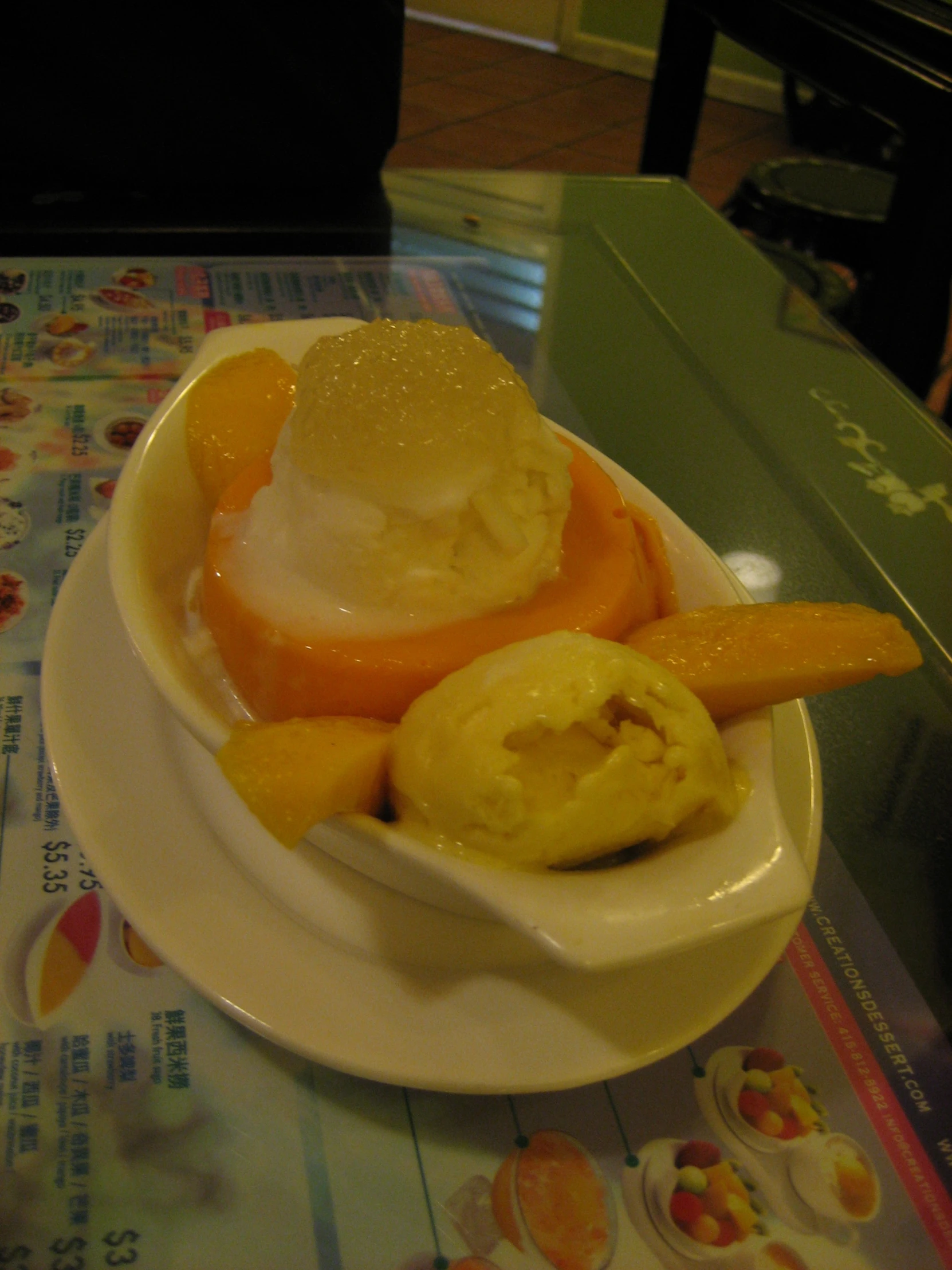 a small plate topped with ice cream and fruit