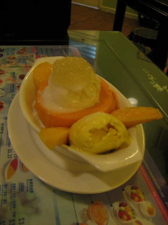 a small plate topped with ice cream and fruit