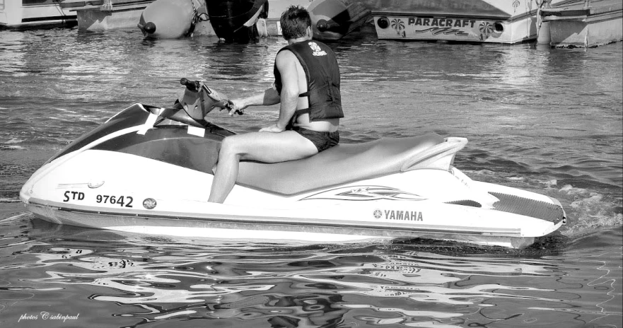 a woman rides a water craft on the water