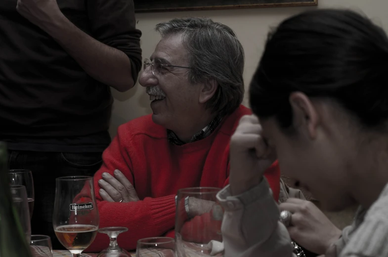 several people sit at a table and smile