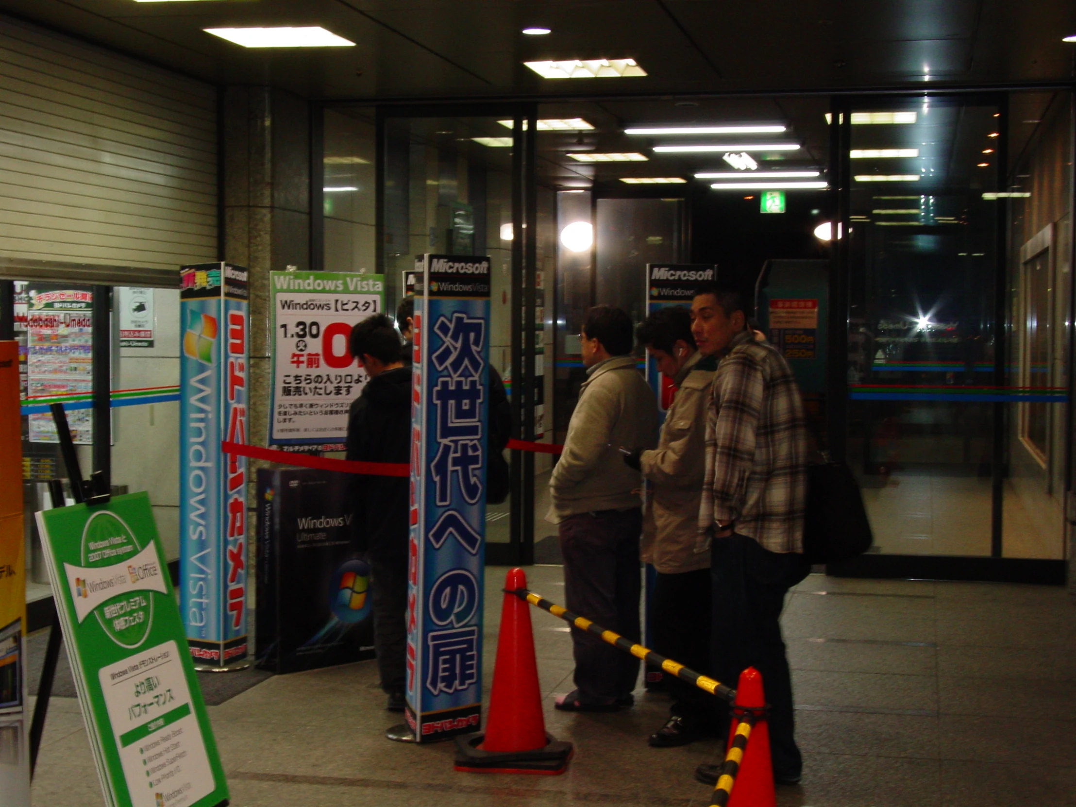 two asian men talking to each other at an expo