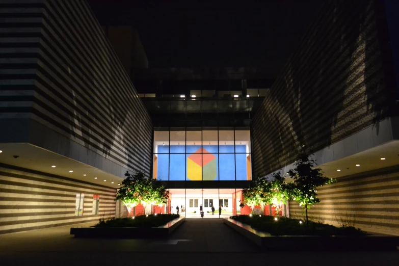 a modern building with large windows in the night time