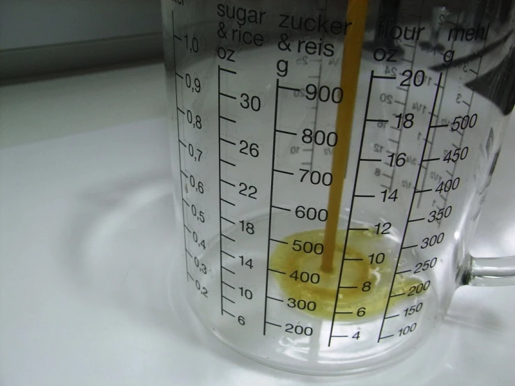 an egg being poured in a plastic measuring cup