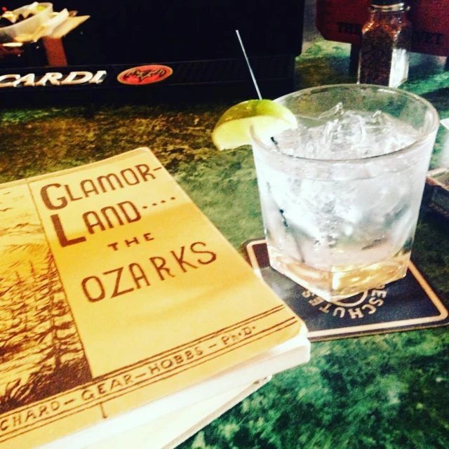 a couple of books next to a glass of water