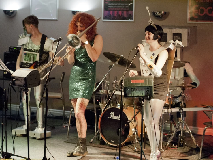 people singing and playing instruments in a room