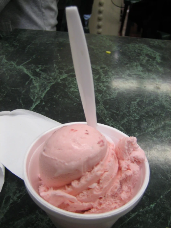 a bowl filled with ice cream sits on a counter