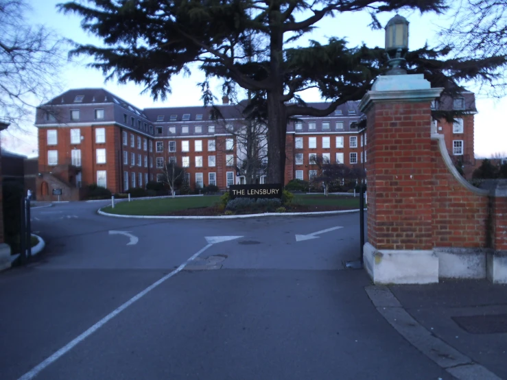 a road with a gate and several buildings