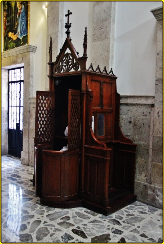 wooden furniture with ornate architecture inside of church