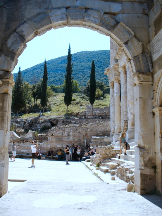 an arch leads to some beautiful ruins