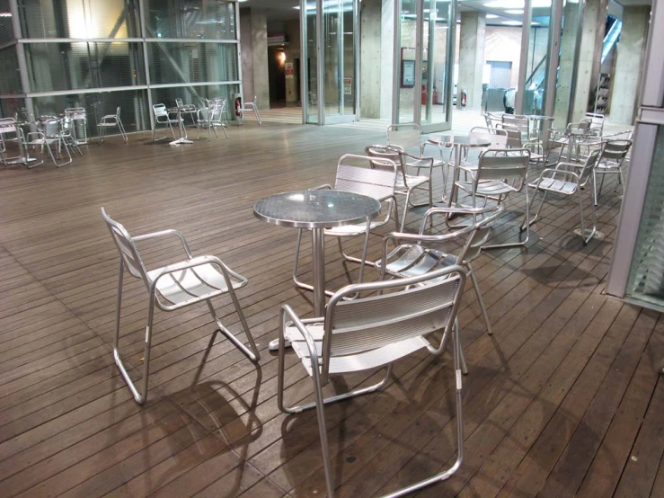 an empty glass enclosed patio area in an indoor facility