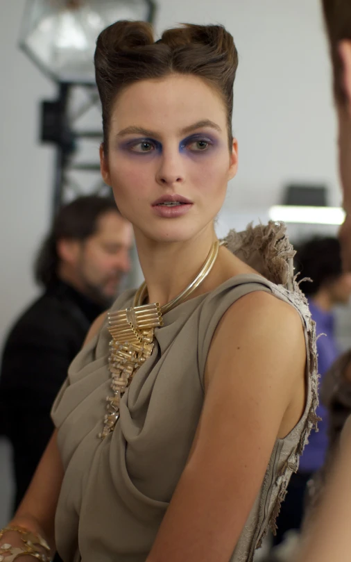 a woman with blue eyes in front of the camera