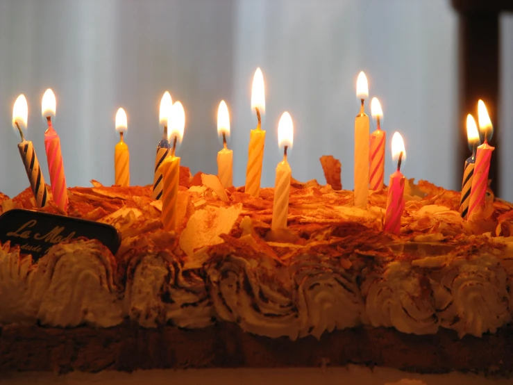 a large cake topped with lots of lit candles