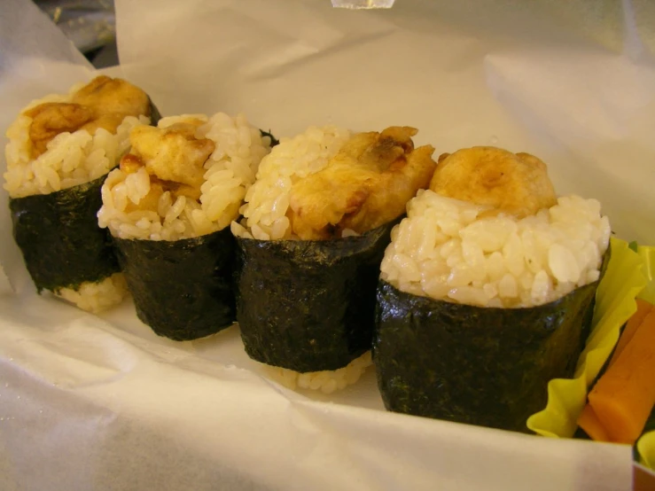 sushi rolls on a white plate with white rice