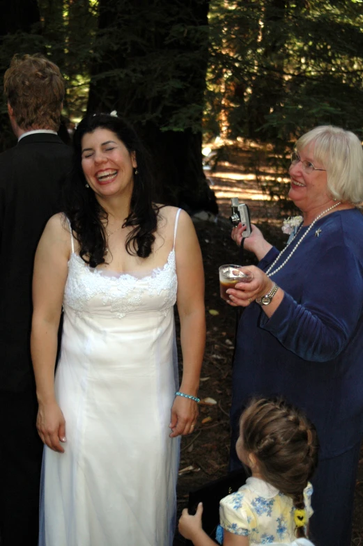 a women standing with two children at a wedding