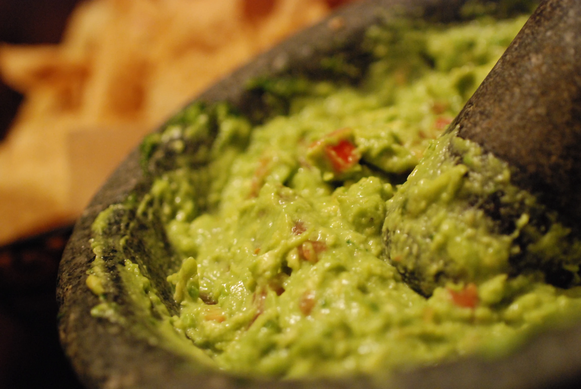 guacamole spread into a bowl with chips