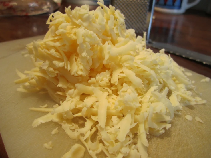 a bunch of grated cheese on a  board