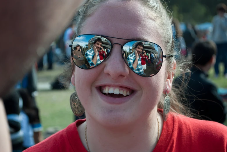 a girl wearing sunglasses that show different images
