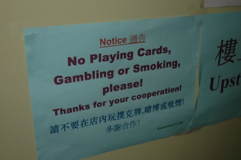 a sign on a wall asking no playing cards
