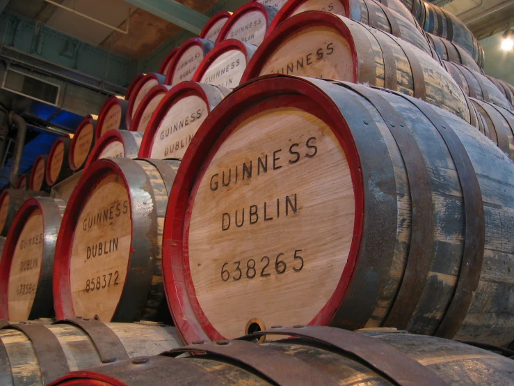 there are lots of barrels stacked in the warehouse