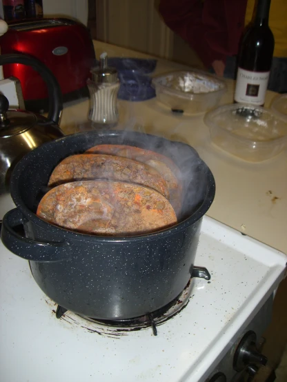 food cooking in an iron pot on the stove