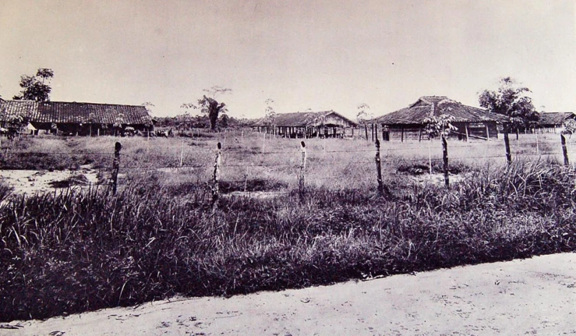 a black and white po shows an old farm land