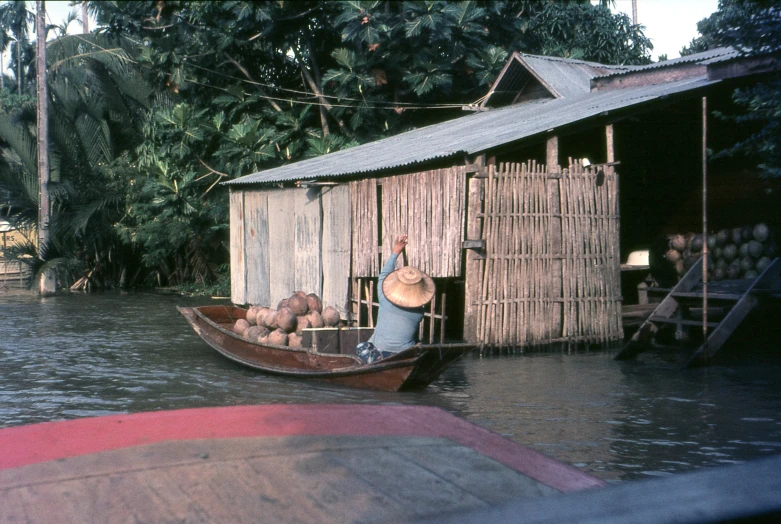 a person in a boat with many wood structures