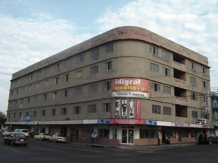 the front of a very tall brown building in india