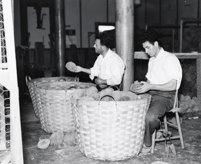 two men working in a factory together