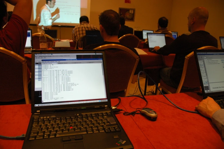 an image of a meeting with laptops sitting on the table