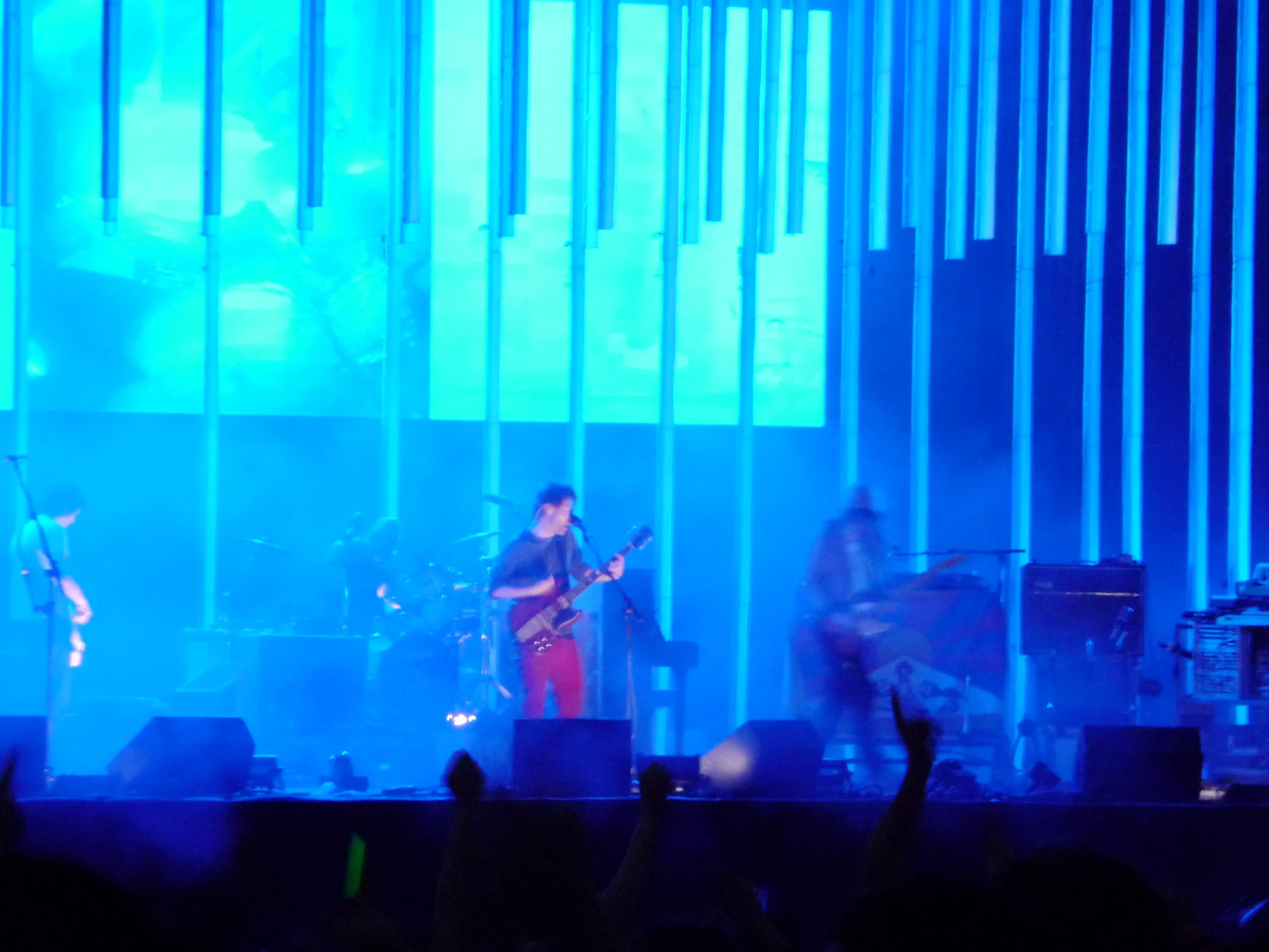 a band of men on stage with a microphone in their hands