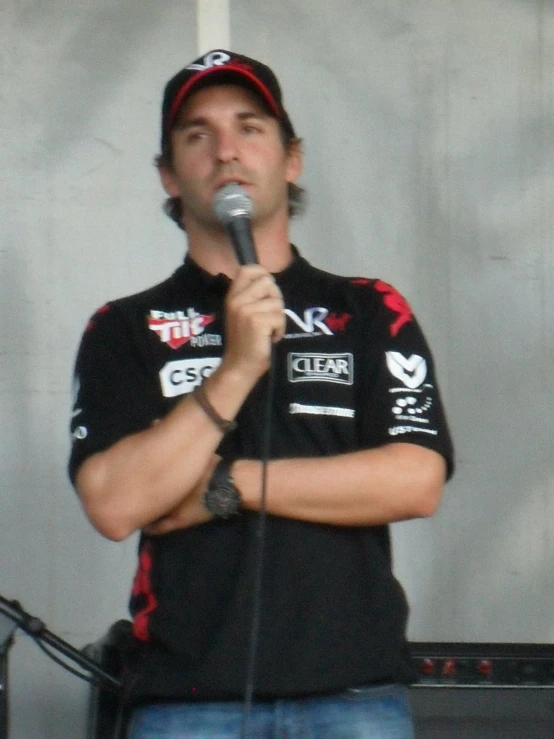 a man holding a microphone talking into a microphone
