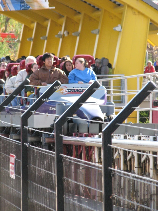 two people ride in the roller coaster at the amut park