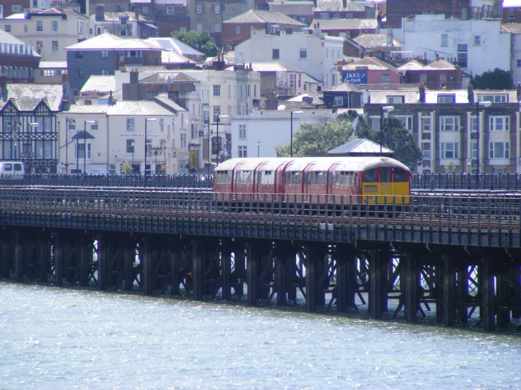 the train is crossing the bridge over the water