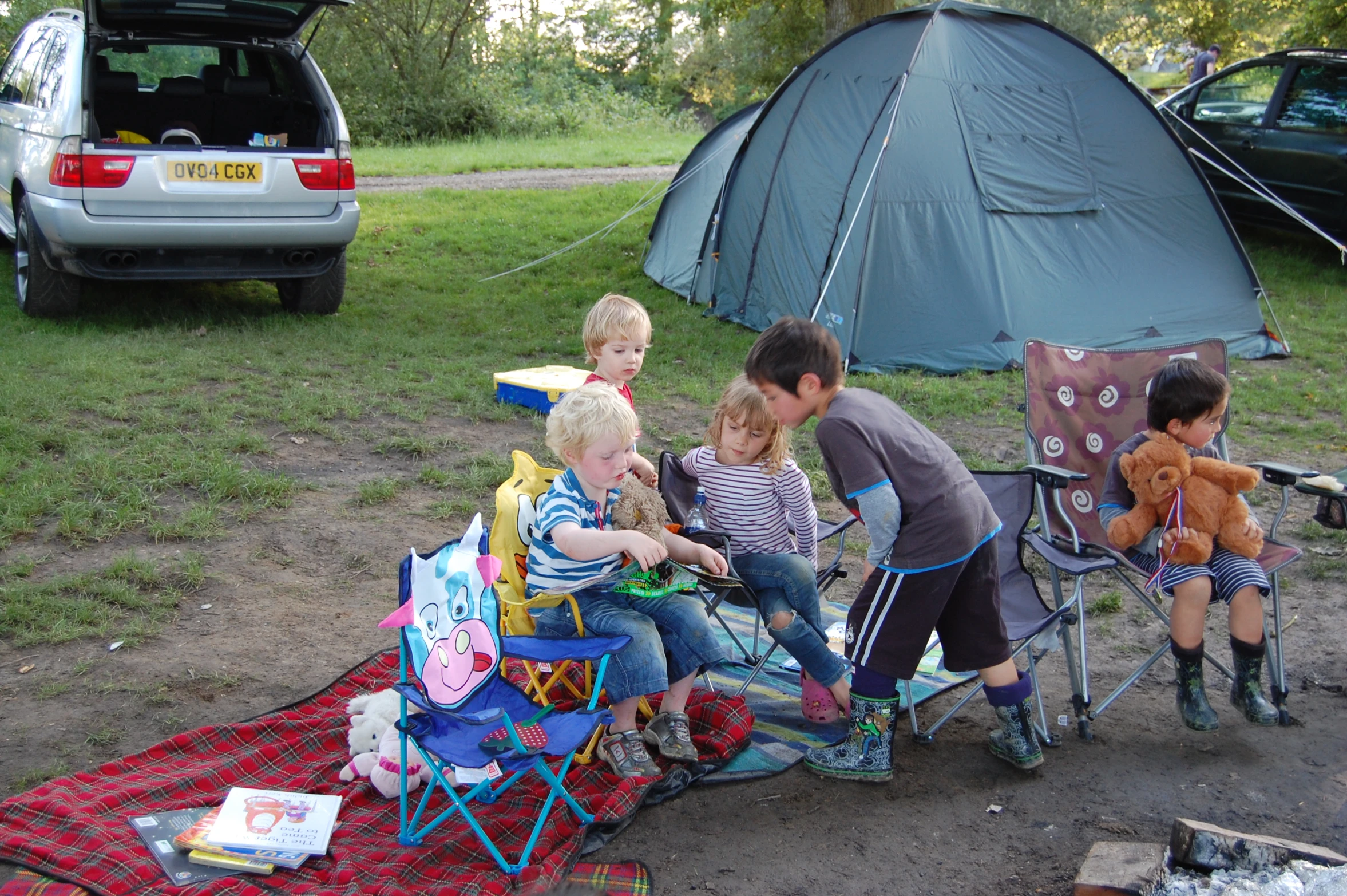 a couple of young children sitting around a camp table